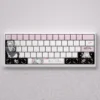 Playful Alisa Mikhailovna Kujou PBT keycap set displayed from another angle, revealing charming schoolgirl illustrations and vibrant pastel keys for custom keyboard.