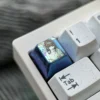 Gallery showcasing the premium titanium alloy Rio Tsukatsuki anime ESC keycap, with vibrant sculpted art details from multiple angles.
