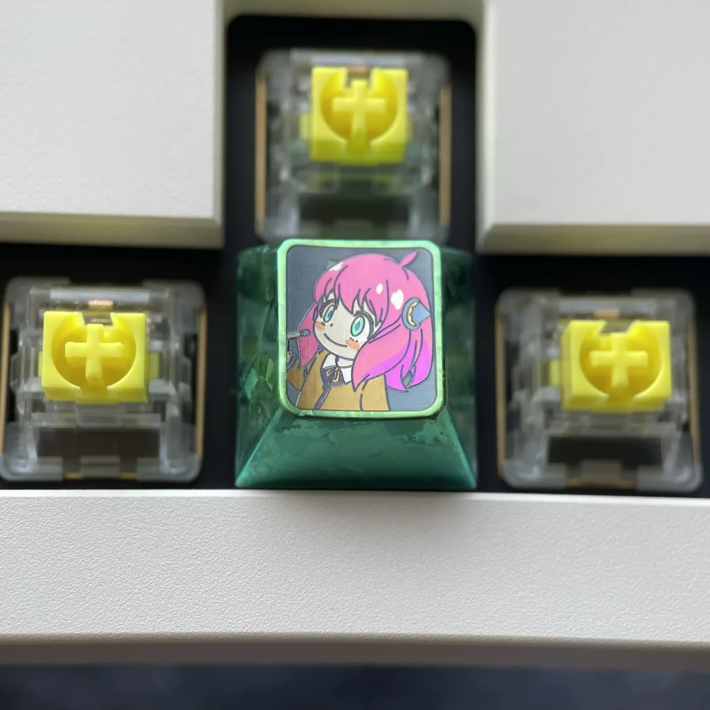 Artistic display of vibrant Anya Forger titanium alloy keycaps, capturing iconic Spy x Family anime flair with lustrous detail.