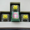Artistic display of the vibrant Anya Forger titanium alloy keycap set, highlighting her iconic anime expressions on each lustrous key.