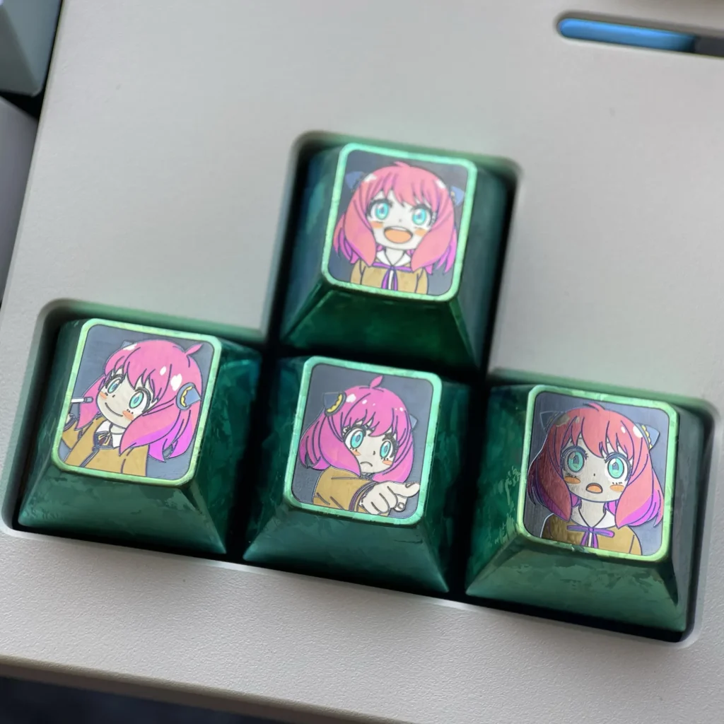 Vibrant Anya Forger Titanium Alloy Keycaps Set showcasing iconic Spy x Family anime designs with lustrous, artistic detail.