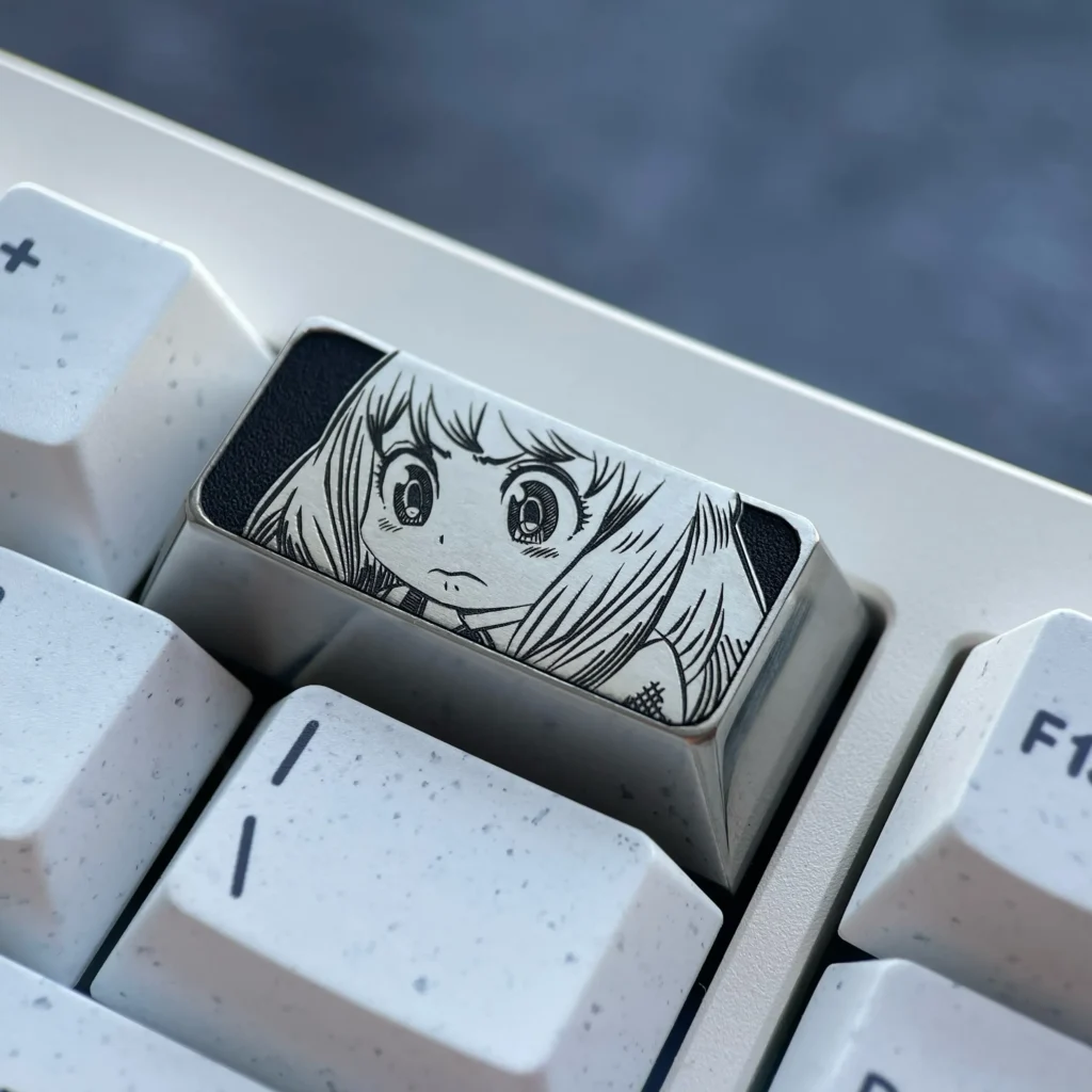 Anya Titanium Keycap gallery showcasing its premium engraved Anya Forger design, sophisticated dark grey titanium, and impeccable craftsmanship.