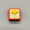 Close-up of a handcrafted artisan leaf keycap, showcasing delicate green leaves beautifully suspended in clear resin, evoking natures calm.