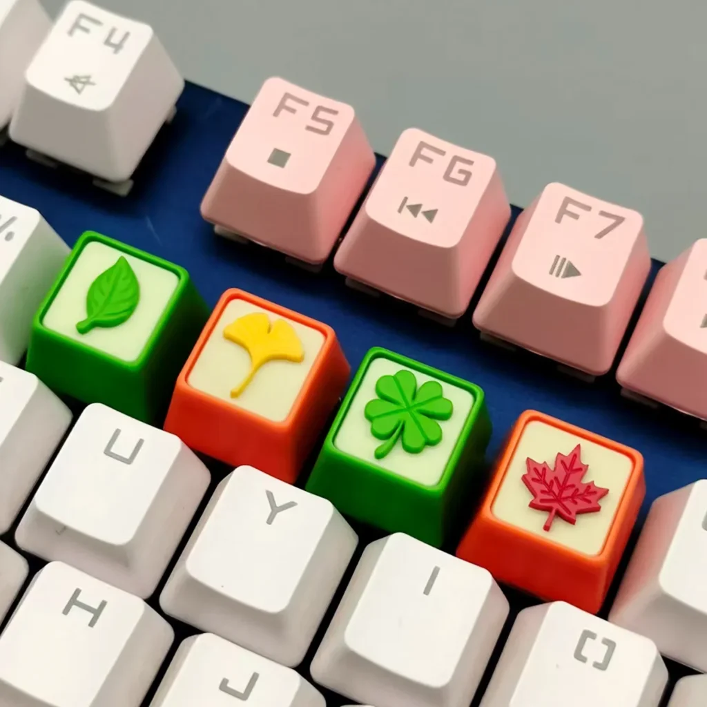 Gallery view of the handcrafted resin leaf artisan keycap, showcasing delicate green leaves embedded in clear resin from multiple serene angles.