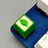 Gallery of the Handmade Resin Leaf Artisan Keycap. Delicate green leaves in clear resin, all angles, highlighting its serene, nature-inspired.