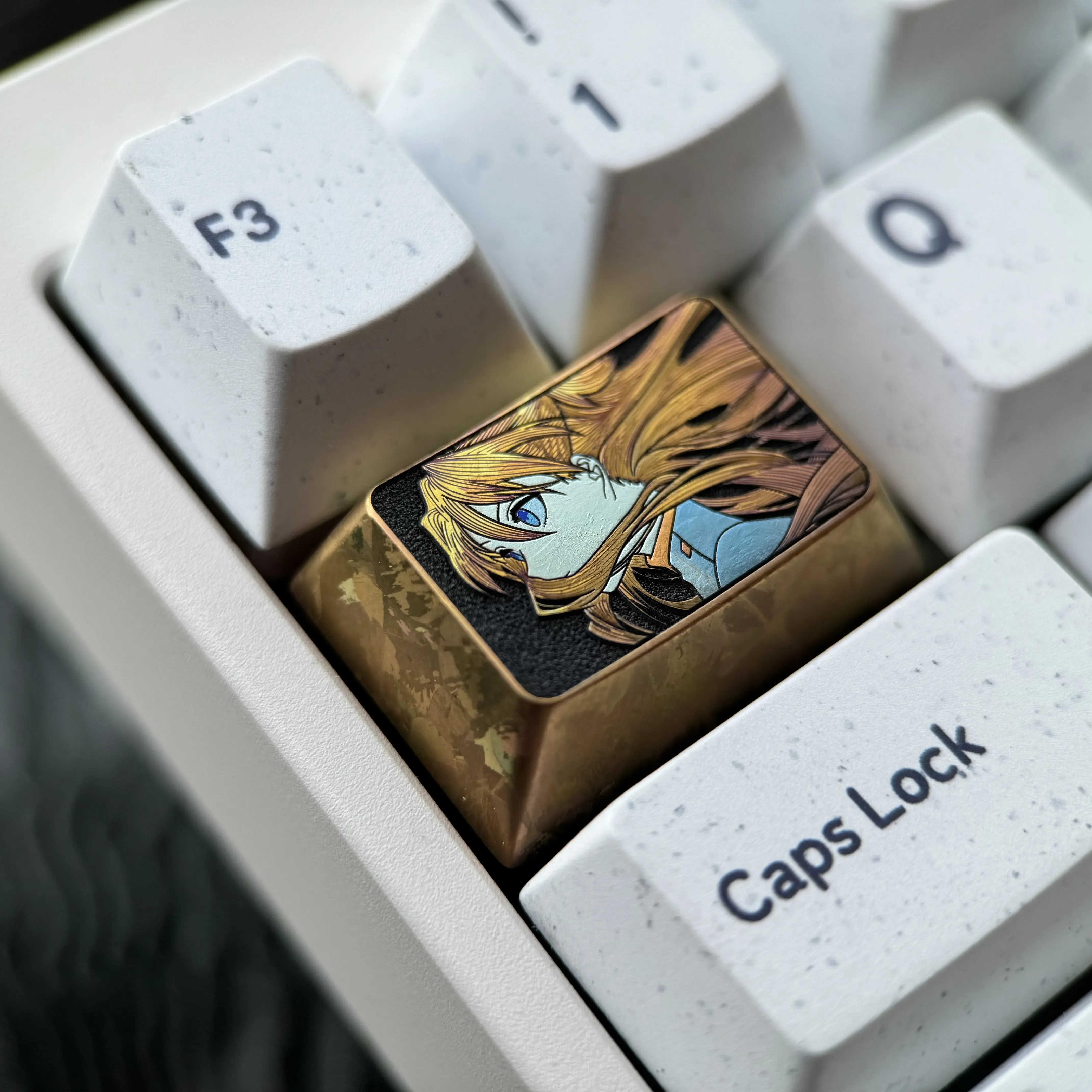 Gallery view of the Asuka titanium keycap, showcasing its precision fine-line art and vibrant colored titanium finish from multiple angles.