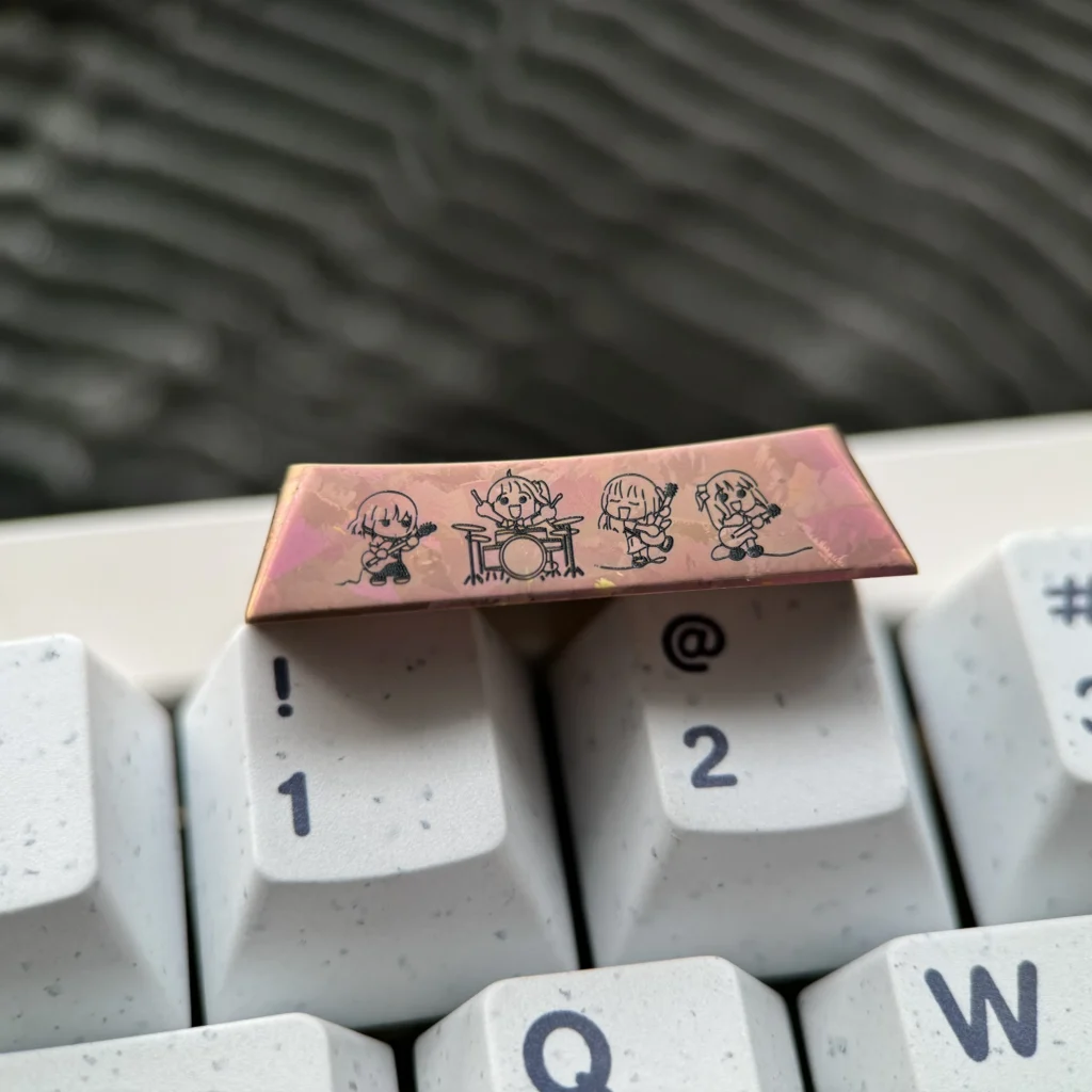 Gallery of the exclusive Bocchi the Rock! titanium keycap. Views highlight vibrant anime art and polished titanium finish, a premium Bocchi Keycap.
