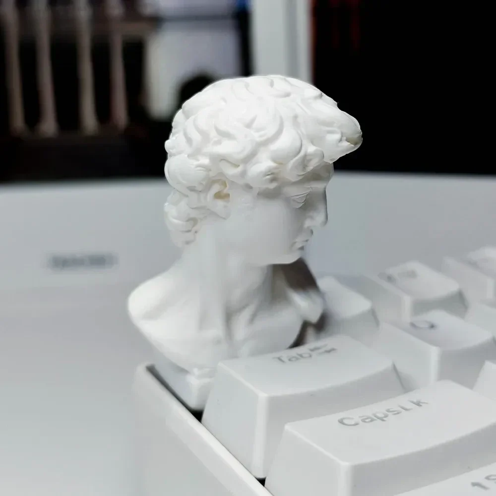 Handcrafted classical David sculpture artisan keycap. See the miniature bust's intricate details and artistic craftsmanship from all angles.