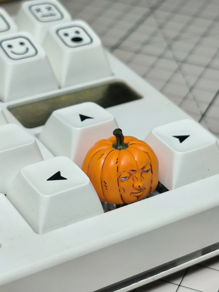Gallery views of the whimsical handcrafted Dungeon Meshi pumpkin keycap, showcasing its intricate artisan details and playful Halloween design.