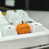 Multiple views of the whimsical handcrafted Dungeon Meshi pumpkin keycap, highlighting its intricate artisan details from all angles.