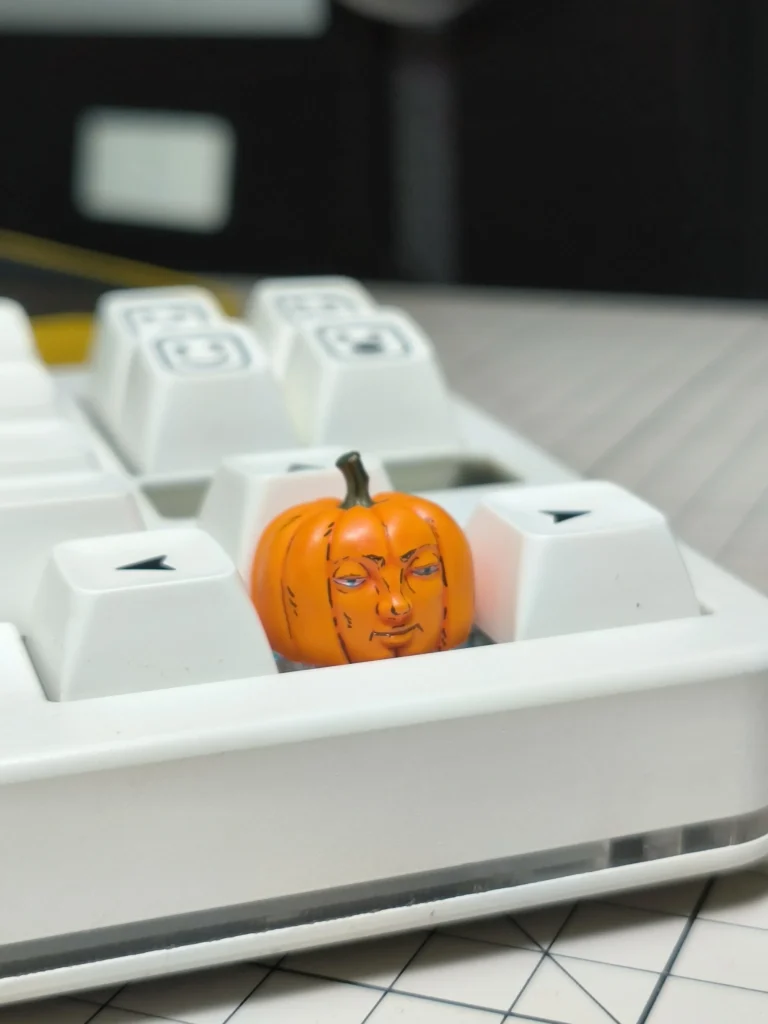 Multiple views of the whimsical handcrafted Dungeon Meshi pumpkin keycap, highlighting its intricate artisan details from all angles.