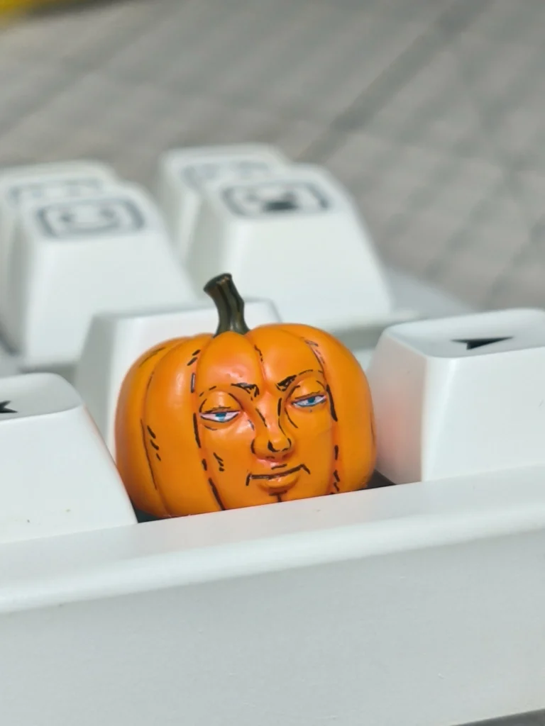 Whimsical handcrafted Dungeon Meshi pumpkin keycap, an anime artisan piece perfect for Halloween, showcasing intricate details.