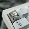 Multiple angles of the hand-sculpted Titanium Frieren keycap, showcasing its precision-carved anime portrait and mirror-finish artisan craftsmanship setup.