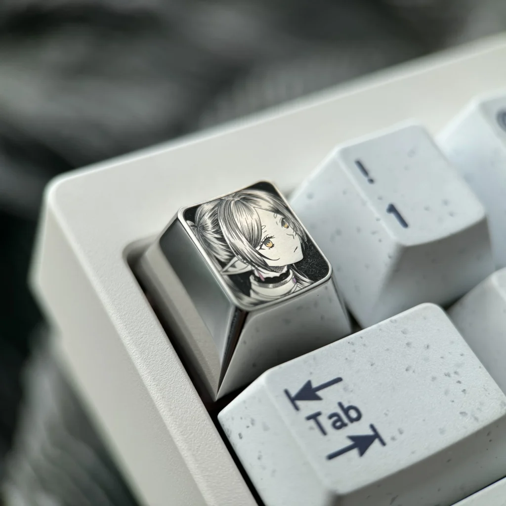 Multiple angles of the hand-sculpted Titanium Frieren keycap, showcasing its precision-carved anime portrait and mirror-finish artisan craftsmanship setup.