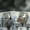 Stunning hand-sculpted Frieren keycap crafted from titanium, showcasing precision anime art and intricate stippling on a mirror finish.