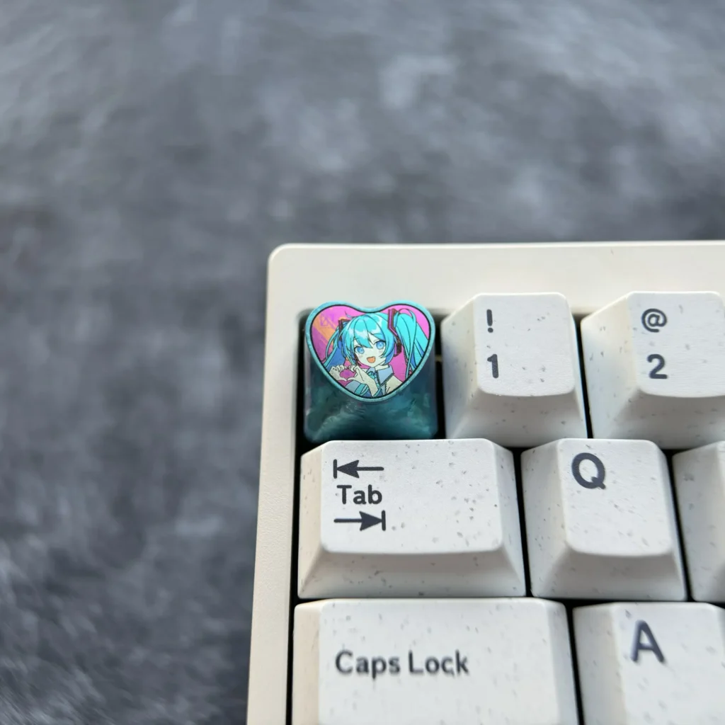 Explore the Official Hatsune Miku Titanium Artisan Keycap from various perspectives, revealing its vibrant heart design, polished titanium finish setup.