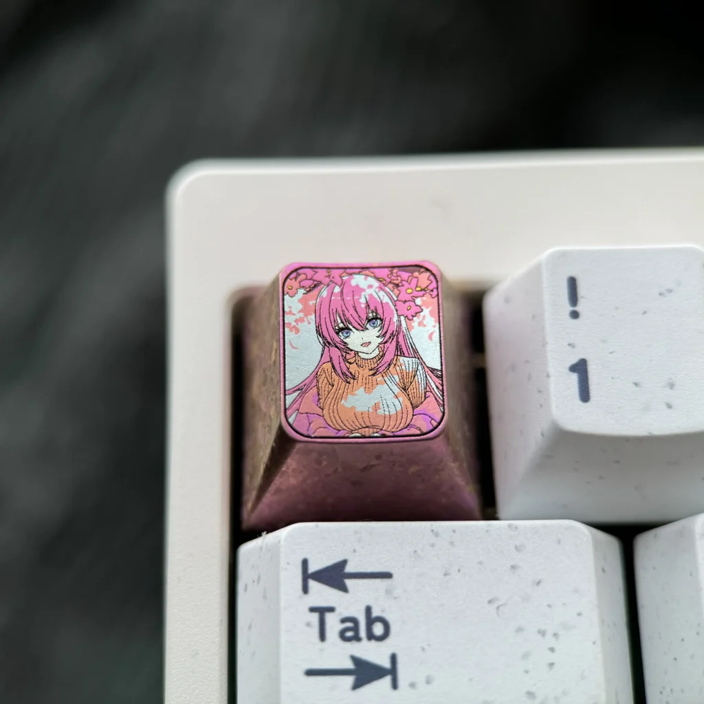 Premium Ichinose Honami titanium keycap, an exclusive anime art piece for mechanical keyboards, featuring vibrant character detail on lustrous metal.