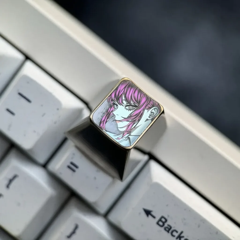 A gallery view of the premium hand-carved Makima titanium keycap, highlighting the intricate line art and sleek alloy from various perspectives.