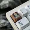 Dynamic views of the premium Titanium Misaka Mikoto keycap, showcasing its vibrant anime character art and exquisite metallic craftsmanship.