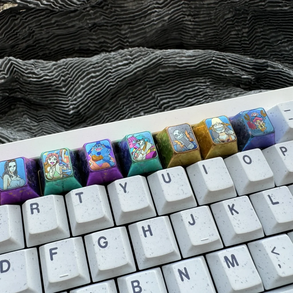 Explore the Premium Titanium ONE PIECE Artisan Keycap from various angles, highlighting its intricate design and vibrant anime details for mechanical keyboard.