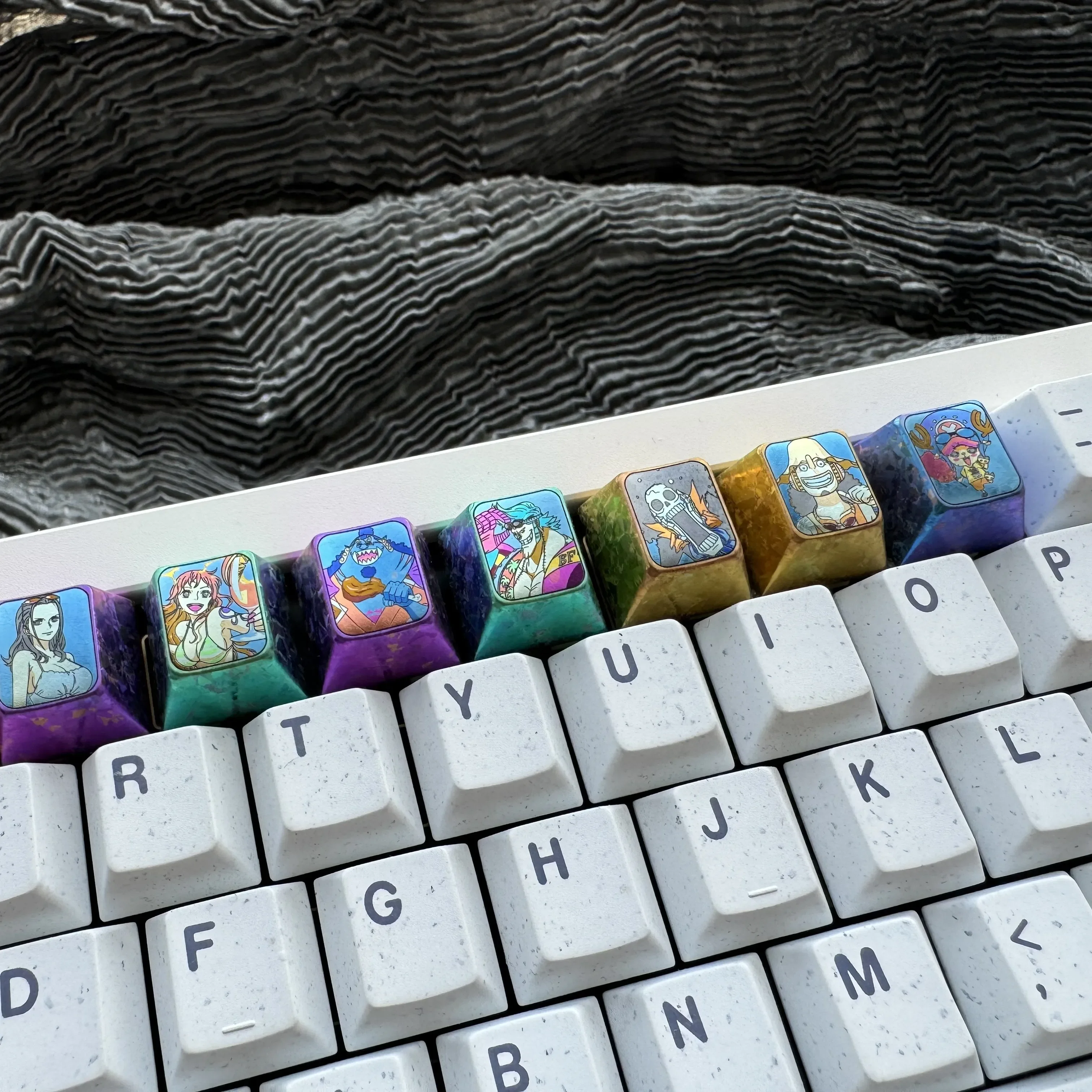 Explore the Premium Titanium ONE PIECE Artisan Keycap from various angles, highlighting its intricate design and vibrant anime details for mechanical keyboard.