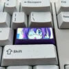 Multiple views of the premium titanium Rikka Takanashi keycap, showcasing its vibrant metallic sheen and intricate anime custom detailing.