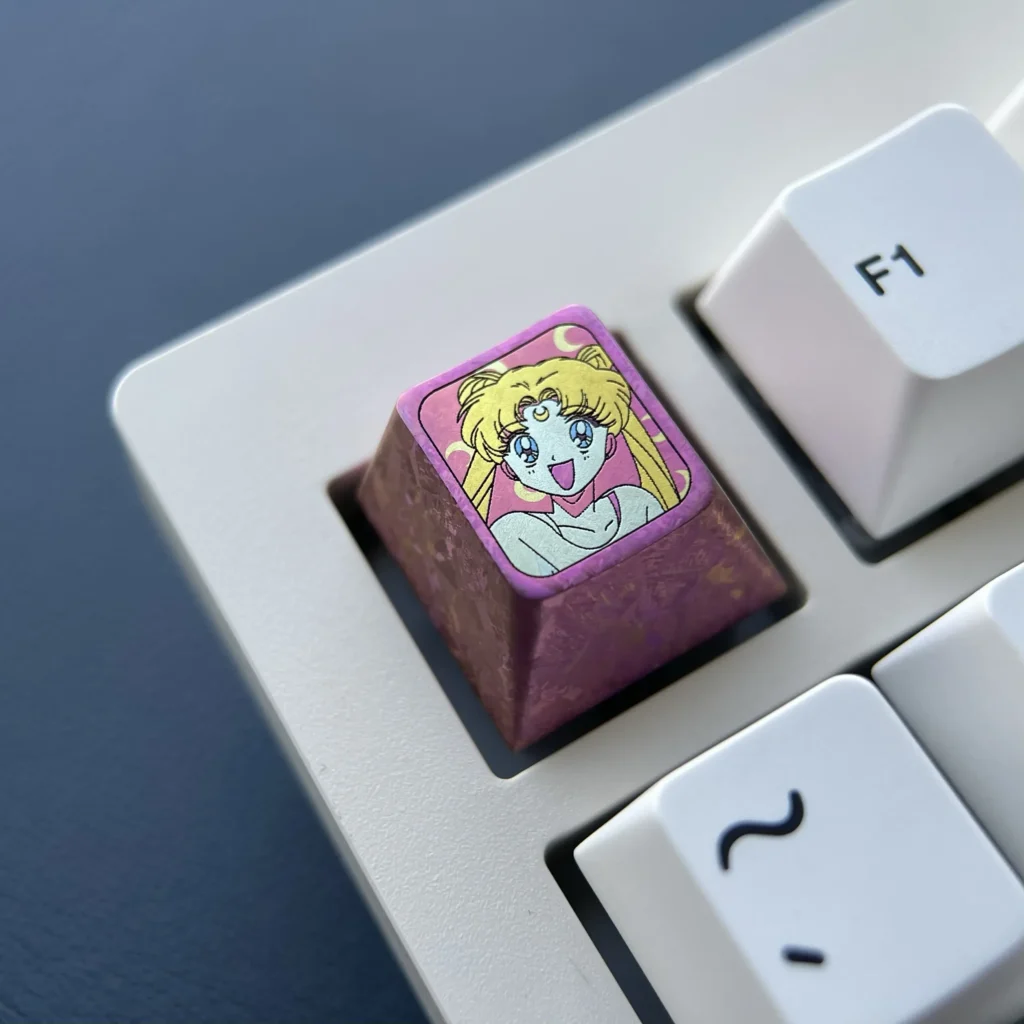 Premium titanium Sailor Moon ESC keycap gallery, revealing its enchanting red anime motif and lustrous finish from various angles.