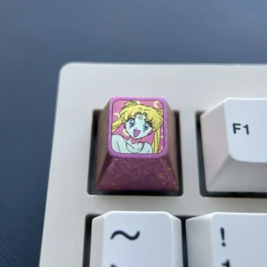 Close-up of a premium titanium Sailor Moon ESC keycap in enchanting red, showcasing iconic anime motifs for a custom keyboard.