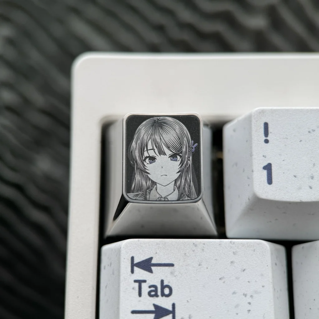 Detailed views of the premium Sakurajima Mai engraved titanium keycap, showcasing its intricate anime art and lustrous metallic finish.