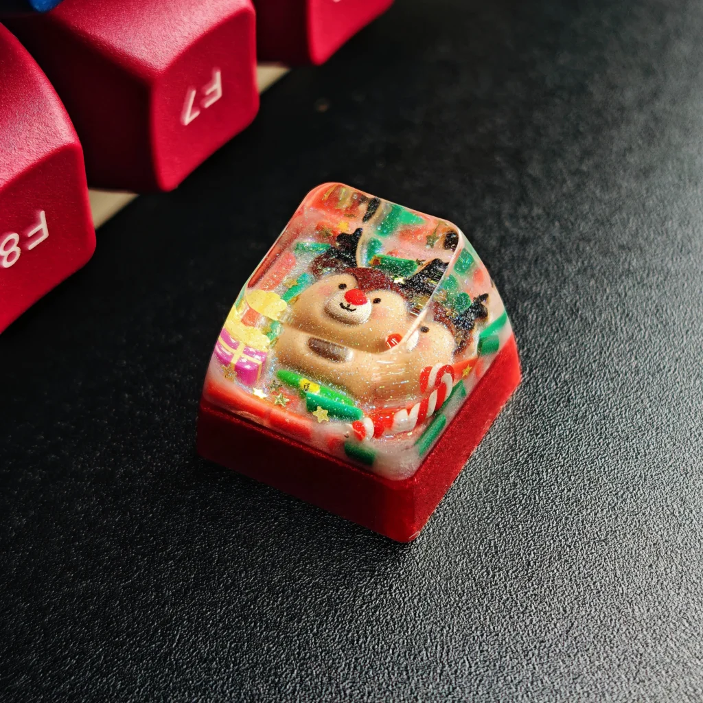 A charming handcrafted Christmas resin keycap, showcasing a whimsical Santa in clear, vibrant resin. A unique festive Christmas artisan keyboard gift.