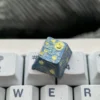 Hand-carved titanium Van Gogh Starry Night keycap from multiple angles, highlighting its intricate relief texture and metallic finish.
