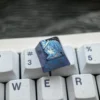 Detailed views of The Shorekeeper Titanium Keycap, a premium artisan ESC key for custom mechanical keyboards with intricate design.