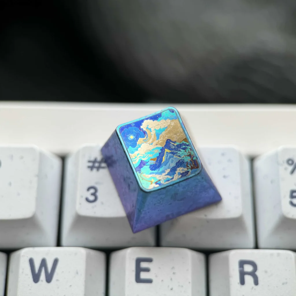 Handcrafted titanium artisan keycap, displayed from various angles, revealing its serene abstract mountain range and durable vibrant metallic finish.
