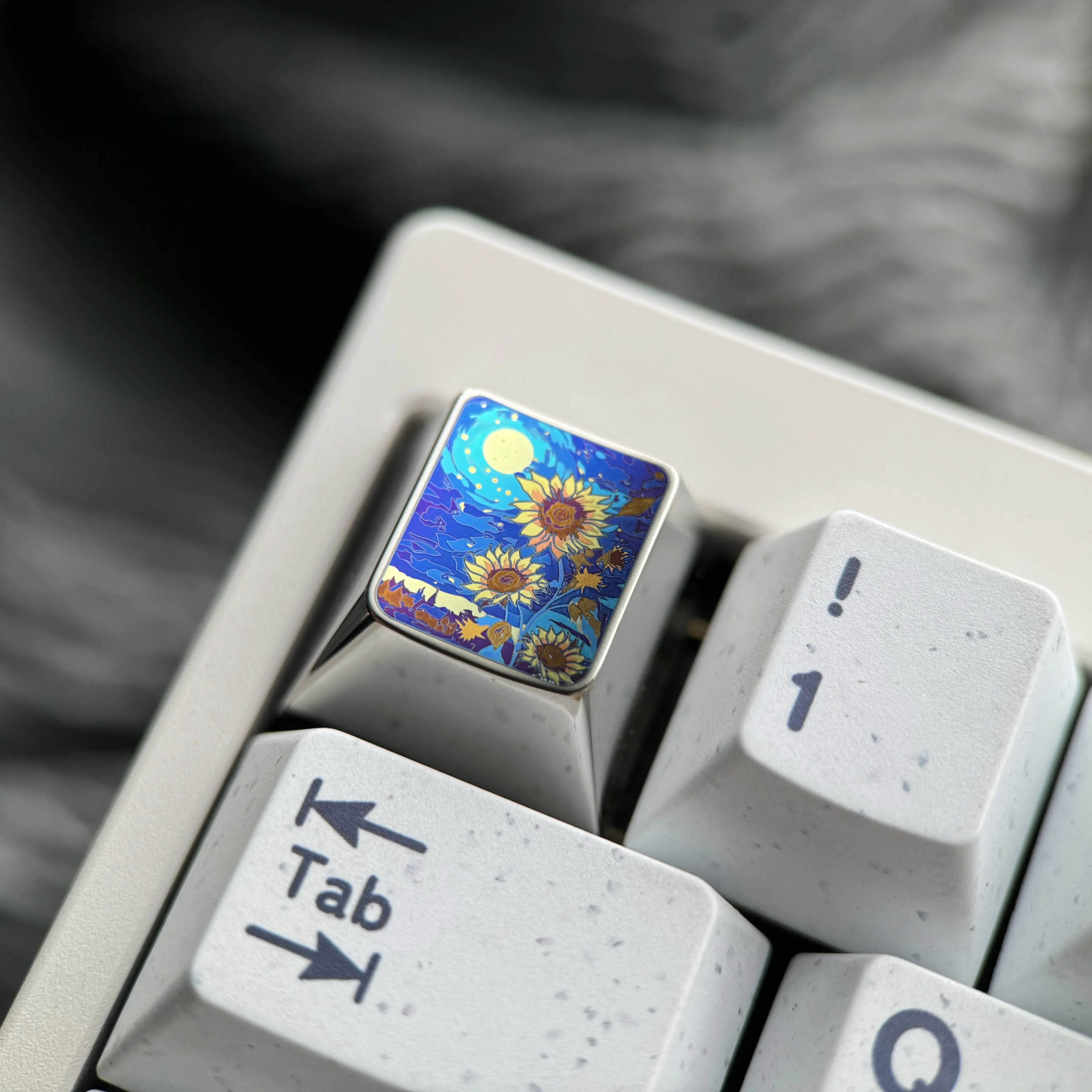 Handcrafted titanium ESC keycap with a vibrant, anime-inspired sunflower blossom, adding an artistic accent to a mechanical keyboard.