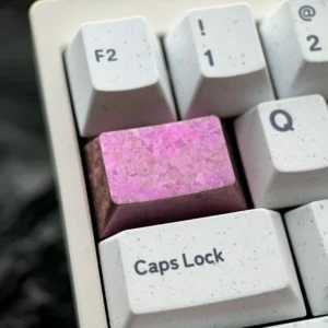A premium titanium keycap featuring a vibrant ice crystal design with jewel-like facets, showcasing its shimmering alloy and artistic touch.