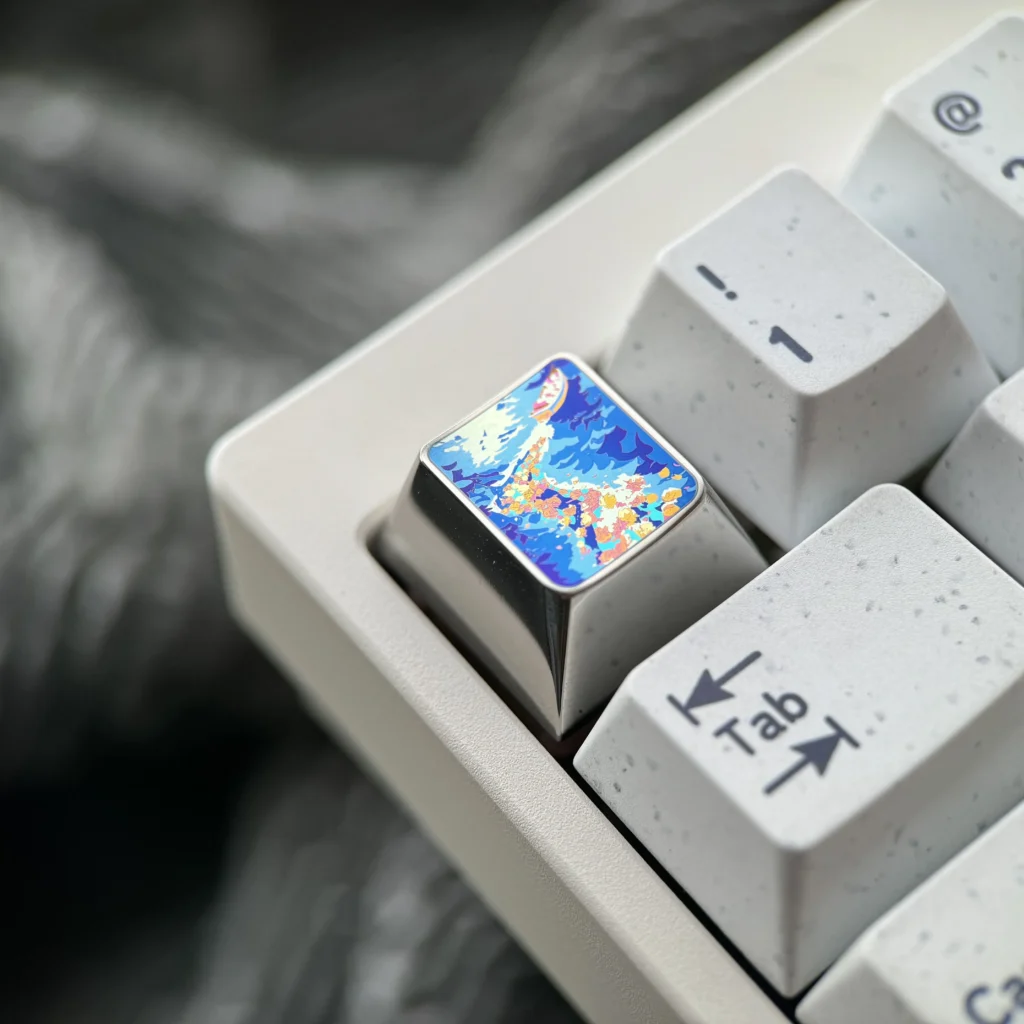 Explore the Vibrant Anime Titanium Wave Keycap from various angles, revealing its dynamic ocean wave design, premium titanium finish, and artistic feel.