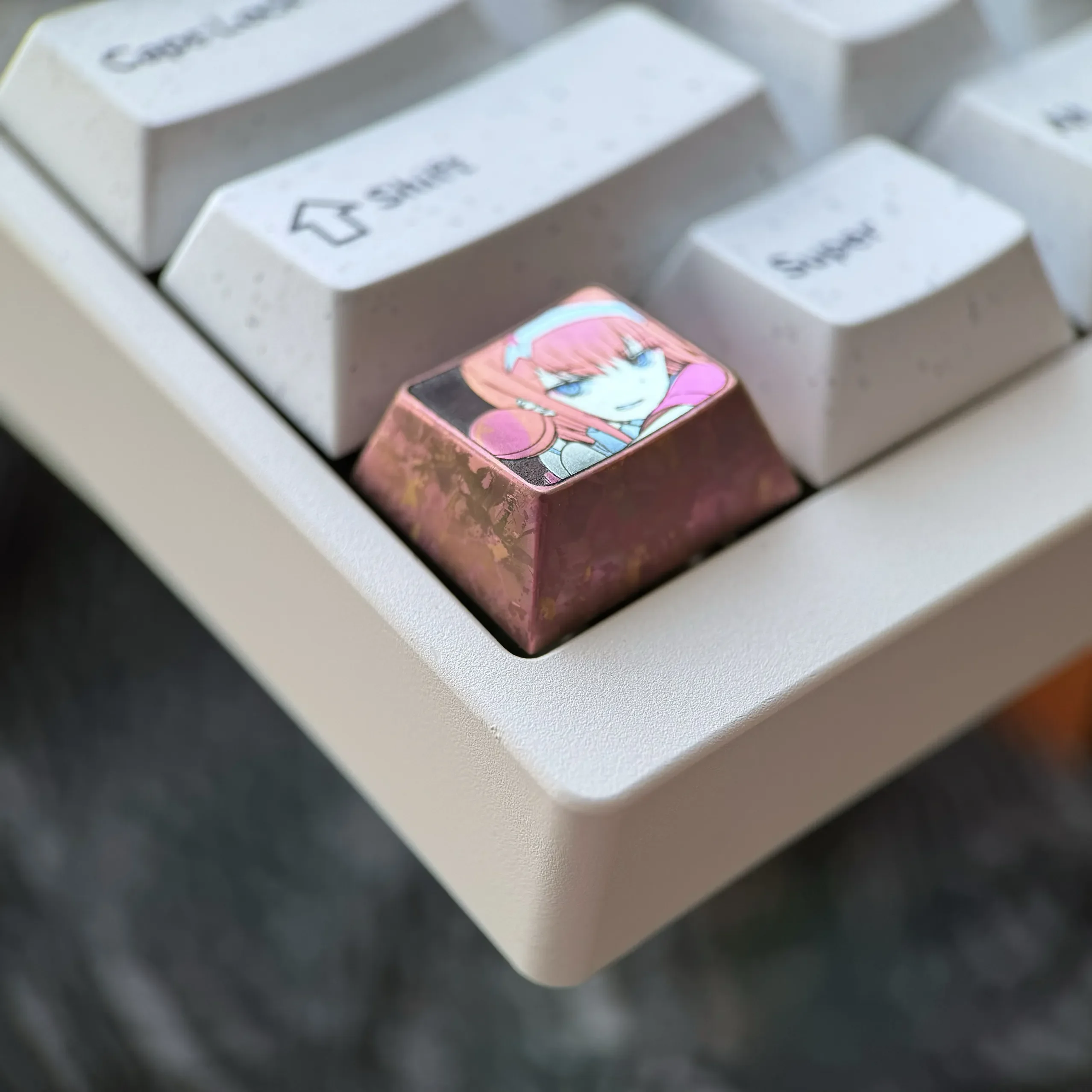 Multiple views of the premium Zero Two Titanium Keycap, emphasizing its premium titanium alloy and vivid artisan finish.