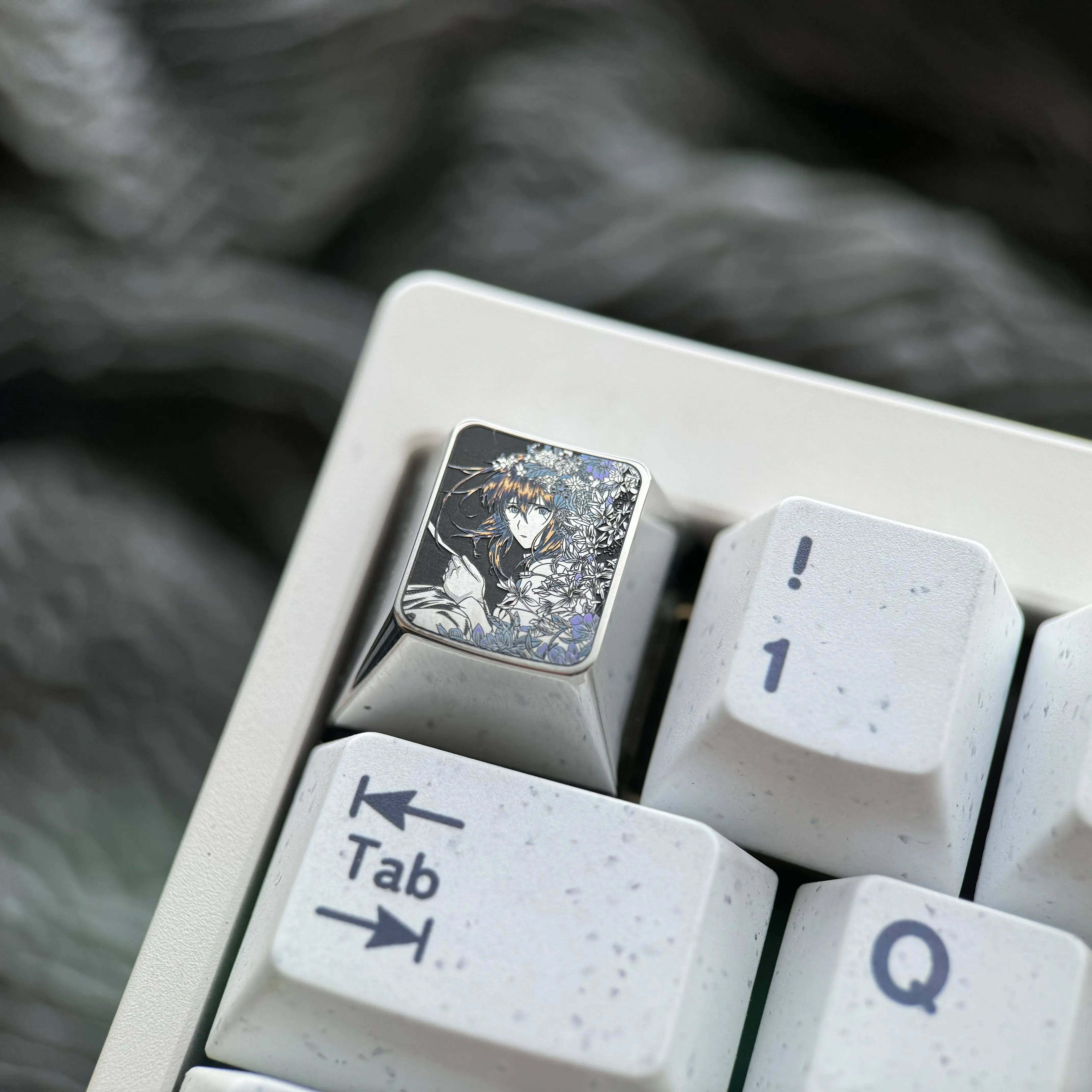 Gallery of the precision hand-carved titanium Violet Evergarden keycap. Showcases intricate character art, lustrous finish from multiple artistic design.
