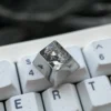 Artisan Violet Evergarden titanium keycap gallery, highlighting intricate hand-carved anime details and delicate lines on its lustrous finish.