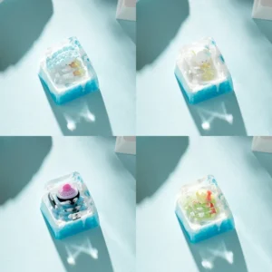 Whimsical handcrafted resin diorama Ice World keycap featuring a cute cartoon penguin playing in a miniature ice world scene.