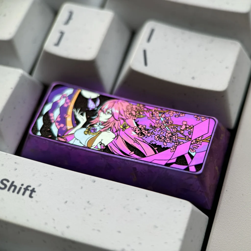 Exquisite Yae Miko Titanium Artisan Keycap, viewed from all angles. Highlights intricate anime design, lustrous metal finish. Vibrant Genshin Impact design.