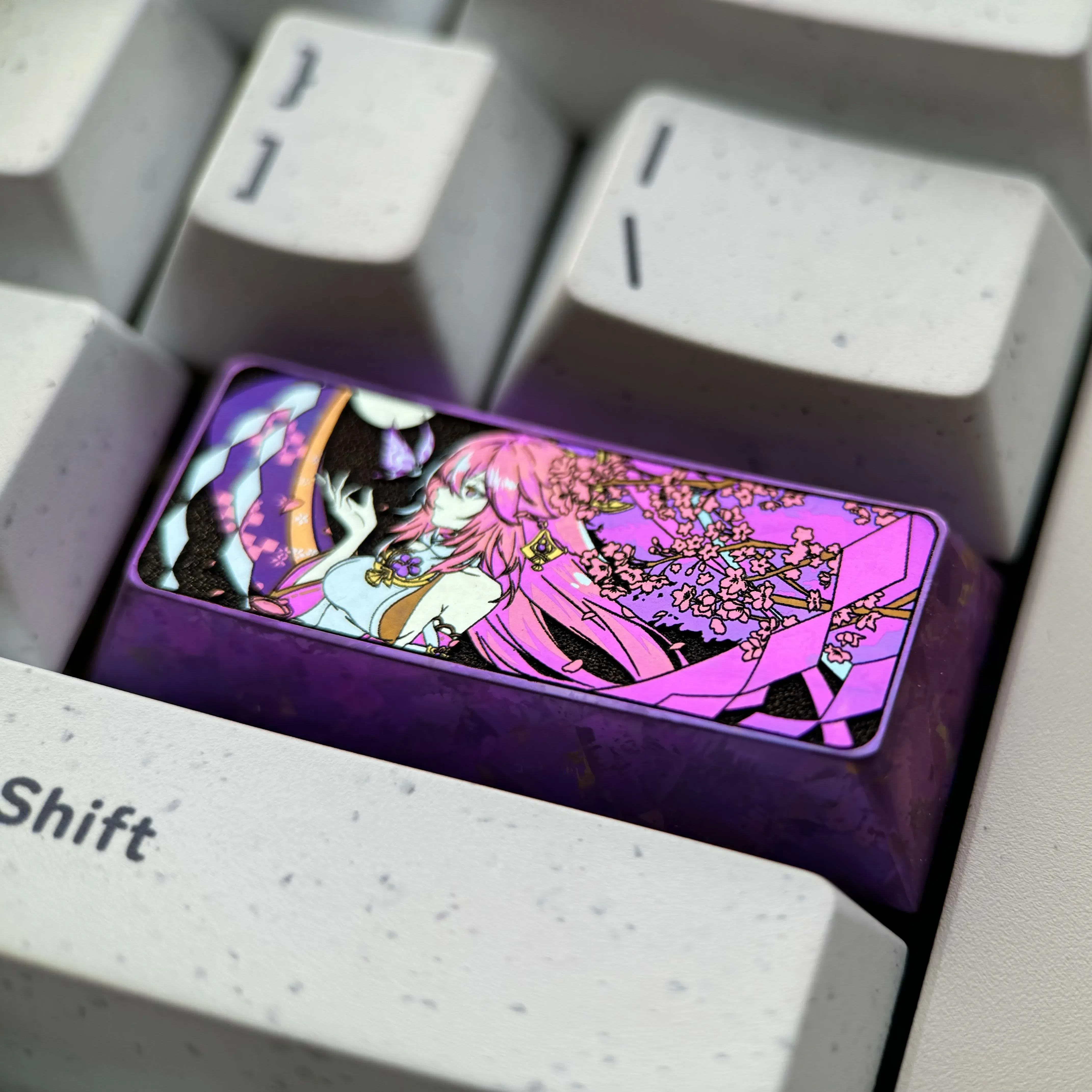 Exquisite Yae Miko Titanium Artisan Keycap, viewed from all angles. Highlights intricate anime design, lustrous metal finish. Vibrant Genshin Impact design.