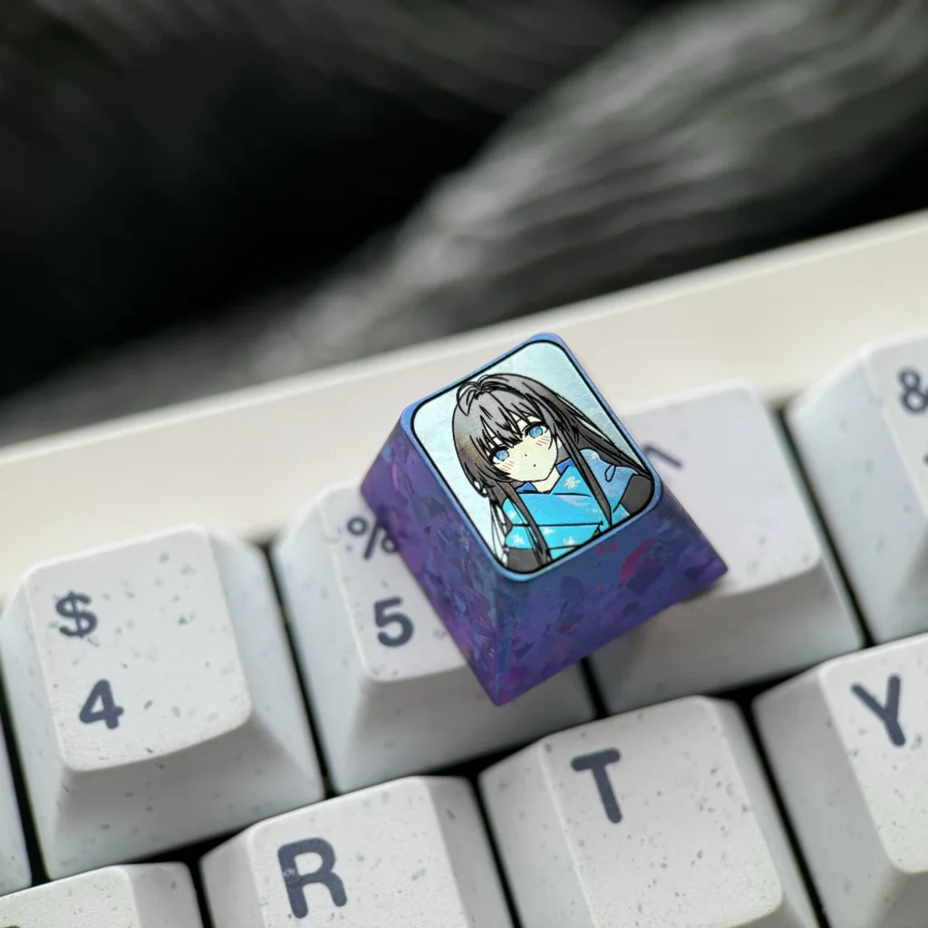 Gallery showcasing the Exclusive Yukino Titanium Anime Keycaps vibrant character illustration on polished titanium. Detailed custom ESC keyboard art.