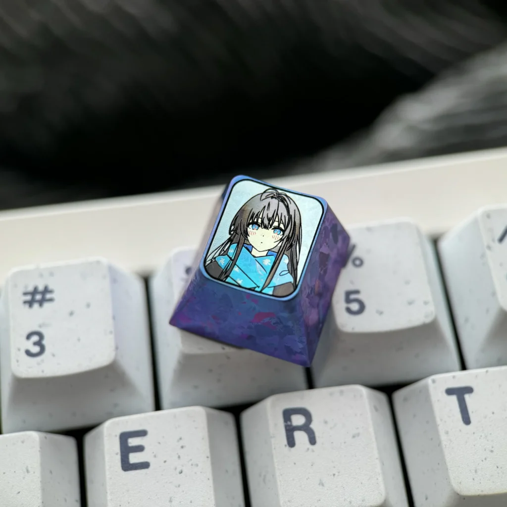 Multiple views of the exclusive Yukino Titanium Anime Keycap, showcasing its vibrant anime character illustration and polished titanium finish.
