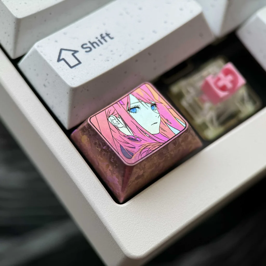 Vibrant Zero Two Titanium Keycap gallery showcasing its durable polished alloy, sleek anime-inspired design, and iconic colors from multiple premium setup.