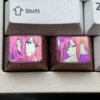 Vibrant Zero Two titanium keycap showcasing iconic anime colors on polished alloy for a durable, sleek custom keyboard accessory.