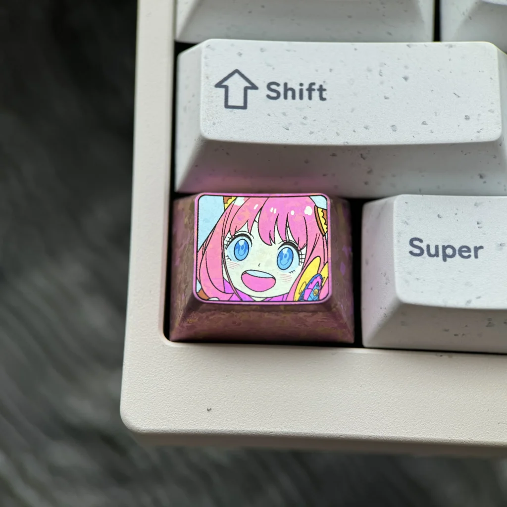 Vibrant Anya Forger anime character on a premium titanium alloy Ctrl Win keycap, showcasing sleek design and iconic detail for enthusiasts.