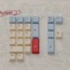 Art Nouveau dye-sublimated keycaps set showcasing intricate floral motifs and organic lines from various angles in soft, muted palettes.