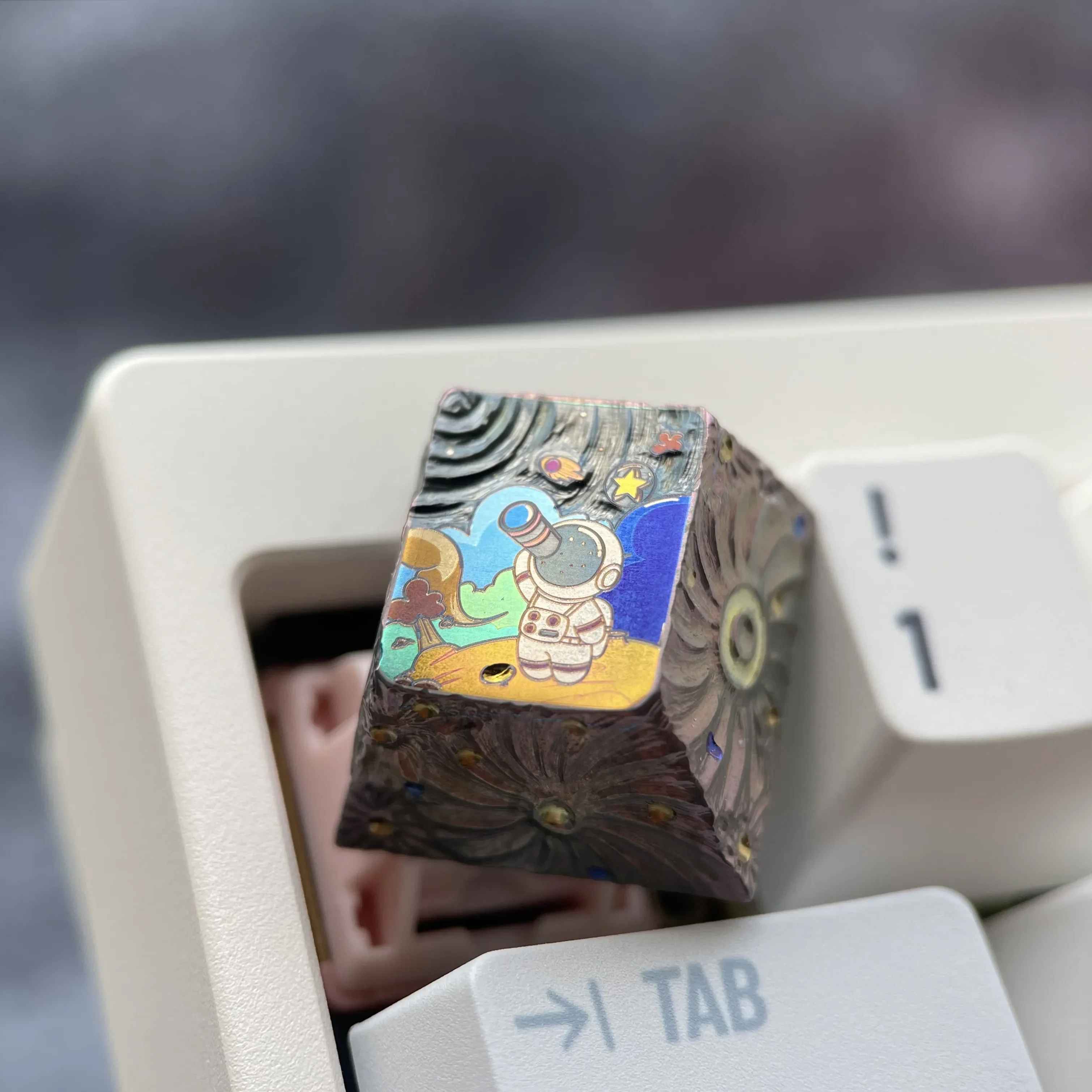A gallery of the hand-carved titanium astronaut keycap, showcasing its intricate metallic relief from various angles and highlighting unparalleled.