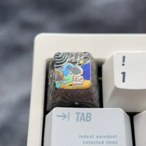 A hand-carved titanium astronaut keycap, masterfully displaying intricate metallic relief and cosmic artistry for keyboard enthusiasts.
